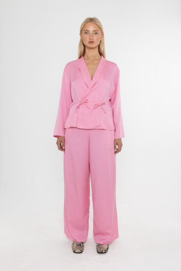 Woman wearing a Deidei Trouser suit with Ella pink tencel wide-leg trousers on a white background