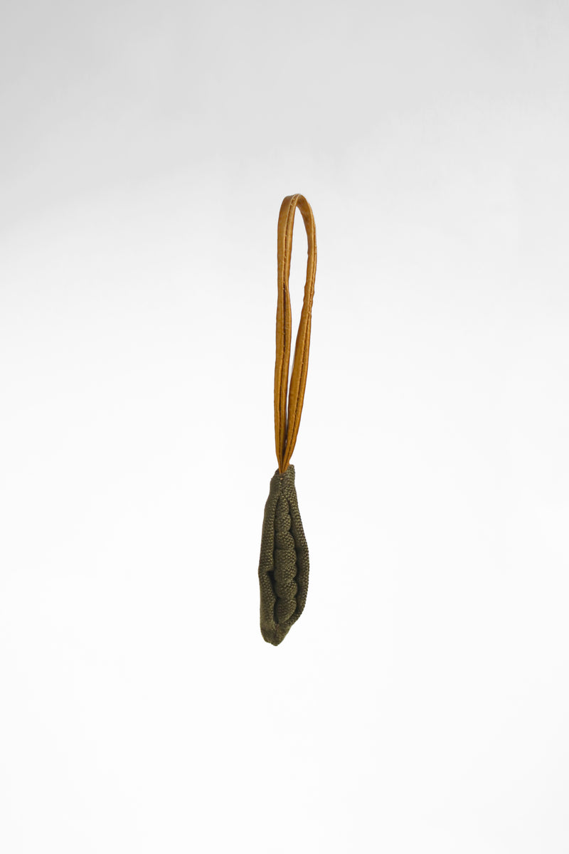 Small green Peapod bag charm with a satin strap