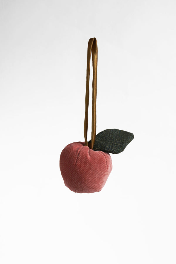 Pink velvet apple with a green wool leaf bag charm
